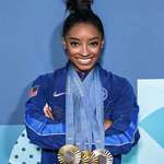 image for Simone Biles with the 4 medals she won in Paris