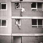 image for Children bouncing on worn out mattresses. England, 1980s.