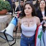 image for The words on her chest say "it's my choice to dress how I want"
