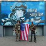 image for American volunteers posing in front of a Russian recruitment ad in Kursk region