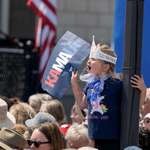 image for Little girl holding Kamala sign