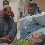 image for Freed hostage Farhan al-Qadi, rescued from captivity after 323 days, with his brother and doctor