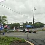 image for A lonely guy selling MAGA merch in a parking lot of an abandoned Rite Aid. Middle PA