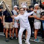 image for Jackie Chan carries torch during Paralympic relay in Paris