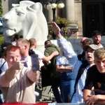 image for A man claiming they aren't nazis while his buddy is giving the salute behind him at a rally