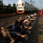 image for In Rawa Buaya, West Java, Indonesians lay on tracks, believing the energy would heal their illnesses