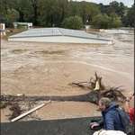 image for Last image of a couple & their granddaughter in Asheville, NC sheltering from the flood on a roof.