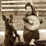 image for A Young Boy Playing The Banjo With His Dog, Circa Early 1900s