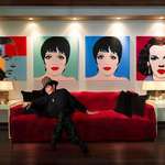 image for Liza Minnelli sitting in front of Andy Warhol's paintings of her and her parents