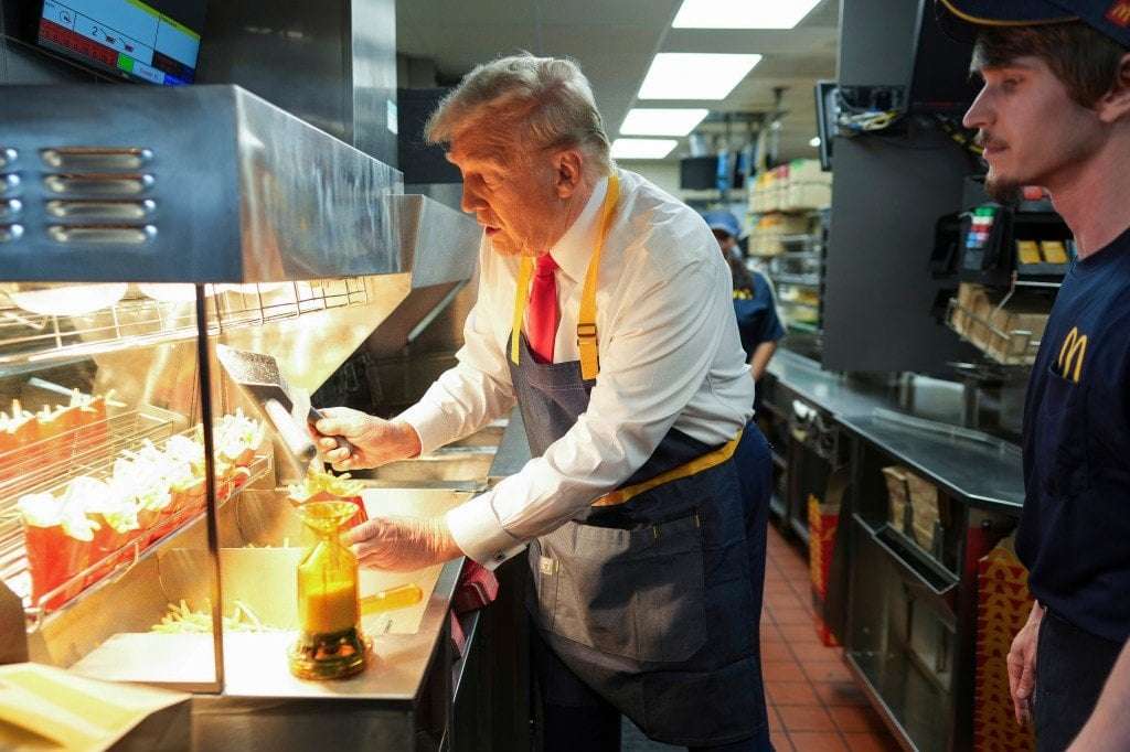 image for Trump 'works' a closed McDonald's drive-thru: 'I wouldn't mind this job'