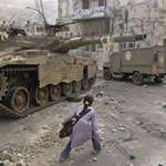 image for A girl creeps past a tank in Nablus in 2003. Photo by Nasser Ishtayeh (AP)