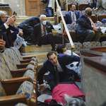 image for Representatives, staffers and observers shelter in place in the House gallery on Jan 6th.