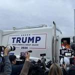 image for Donald Trump riding around in a garage truck