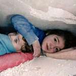 image for 7-year-old girl was found under rubble with her hand over her little brother's head to protect him.