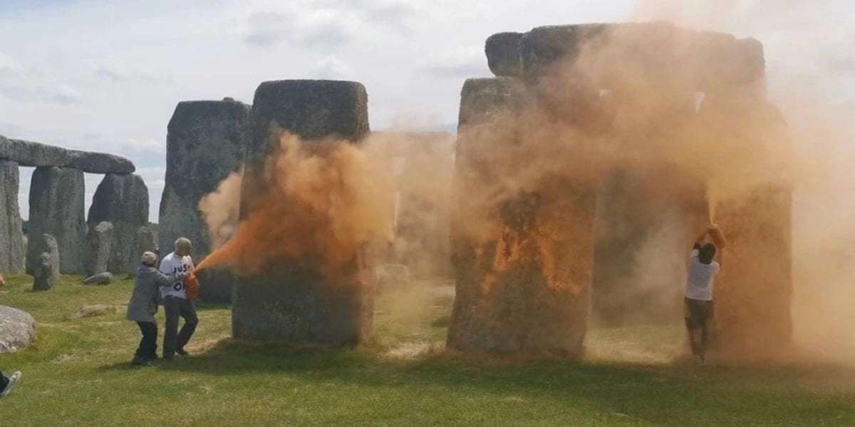 image for Stonehenge: Just Stop Oil protesters charged with destroying ancient protected monument after throwing orange paint powder at monument