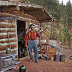 image for A prospector standing outside a log cabin in Pikes Peak, Colorado in 1900. 124 years ago
