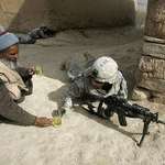 image for An Afghan man offers tea to soldiers