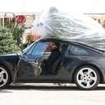 image for Keanu Reeves picking up a Christmas tree.