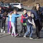 image for 12 years ago today, police escort scared children after the Sandy Hook Elementary Shooting
