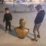 image for Syrian children urinating on the statue of the former syrian dictator Bashar Al Assad