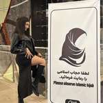 image for Iranian women standing in front of a poster