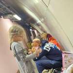 image for A girl unpacks a Christmas present in the Kyiv metro, waiting out the russian missile threat.