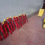 image for Roses honoring victims of the NOLA truck attack placed next to the unused anti-vehicle barriers