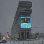 image for Snowy Moscow, January 1, 2025. Putin on the screen declares “Year of the Defender of the Fatherland”