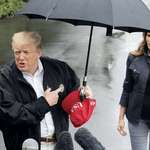 image for Trump shows how not to be a gentleman staying dry under the umbrella while Melania walks in rain