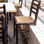 image for This restaurant made two-legged chairs for tables near a window