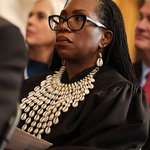 image for Ketanji wore a collar made of cowrie shells to ward off evil spirit during Trump's Inauguration.