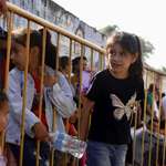 image for Children wait stranded with their parents after their permits to enter the US were cancelled.