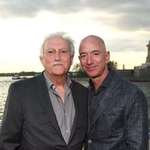 image for Jeff with his Cuban refugee stepfather Miguel Bezos in front of the Statue of Liberty.