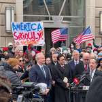 image for Congressmen and protesters outside the USAID