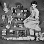 image for 1947, Woman poses with a week's worth of groceries, costing her $12.50 ($166 adjusted for inflation)