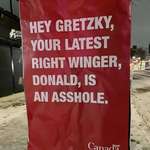 image for A poster in Calgary calling out Gretzky for cozying up to Donald Trump.