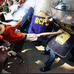 image for A protester kicking a police shield in the Philippines.