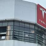 image for Sign from employees at Tesla dealership: "We Hate Him Too"