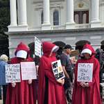 image for Women at Sacramento dressing as Handmaids to protest against Trump during the 50-50-1 protests
