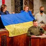 image for Ukraine President Zelensky handes over a battle flag to representatives of US Congress. Dec. 2022