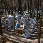 image for Ukraine officials exhume a mass grave of 436 bodies from Izium made by Russian invading forces -2022