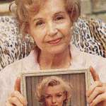 image for An old woman holding a photo of her sister, Marilyn Monroe