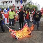image for People burn American flags during an anti-Trump protest in Panama City, Panama.