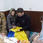 image for Jewish Ukrainian President, kneeling with Muslim Ukrainians at Iftar, signing Ukrainian flag