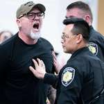 image for Asheville, North Carolina: A veteran being escorted out of a town hall for using his free speech.