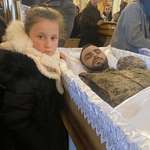 image for Ukrainian child next to her 26 year old father killed in combat.