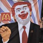 image for Protesters display an image of Trump during a demonstration.