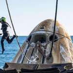 image for SpaceX support member is airborne while working to lift the SpaceX Dragon capsule