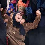 image for Mother of Ali al-Hneiss, killed in an a Southern neighbor’s strike, weeps during funeral in Syria