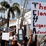 image for Protesters against the work of Elon's "Dept. of government efficiency" outside a Tesla dealership.